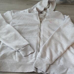 Girls Light Gray Zip Hoodie with Subtle Chest Logo